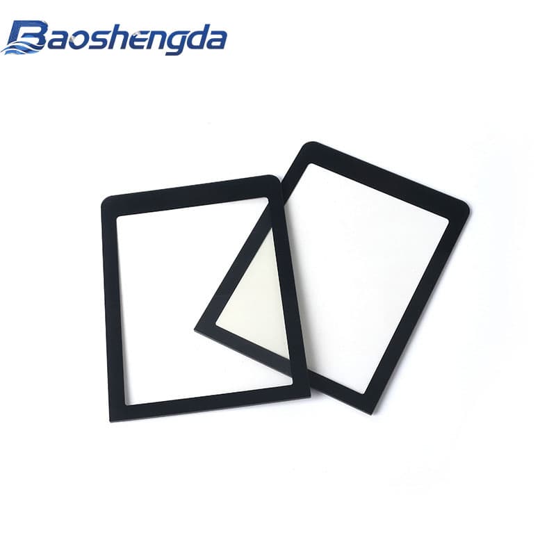 Two black printed graphic overlay samples with clear display windows on a white inspection background